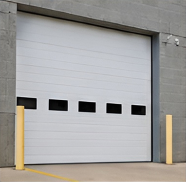 White industrial garage door with bollards