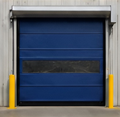 Blue industrial roll-up door with yellow bollards